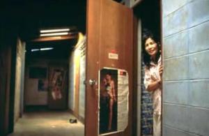 A sex worker stands in a doorway at Shipha House, a brothel in Northern Thailand