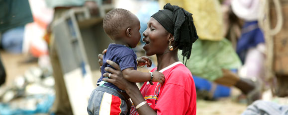 African woman holds child