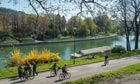 People cycling on the banks of the Po river in northern Italy