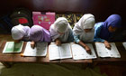 Indian Muslim girls reciting the Holy Quran in their class room at Madrasatur-Rashaad religious scho