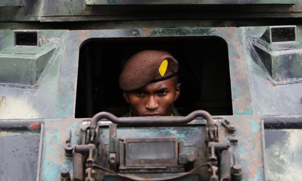 A member of Honduras's military police sits in a tank during a presentation in Mateo. The new military police unit consisting of 5,000 personnel who will be in charge of police operations, public order and safety.