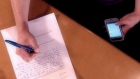 student-cheating-smartphone-paper