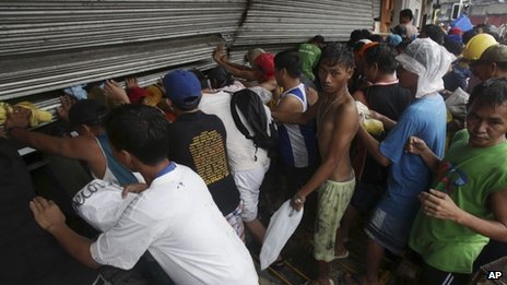 Residents in Tacloban push shutters of grocery shop in attempt to get food - 10 November