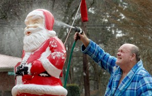 Allen Short decided that Santa needed a good cleaning and a fresh coat of red paint. In preparation for the new paint, Short scrubbed and rinsed off the 25-year-old plastic Santa at his Oxford Road, Henderson, NC, home Wednesday afternoon Dec. 4, 2013. (AP Photo/The Daily Dispatch, Mark Dolejs)
