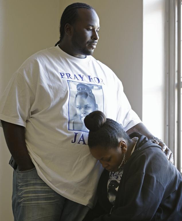 Marvin Winkfield places his arm around his wife Nailah Winkfield, the mother of the 13-year-old. The family has argued that because her heart and lungs are functioning she should not be taken off life support.