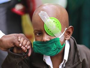 A child suffering from cancer leaves the Tata Memorial cancer treatment and research center on World Cancer Day in Mumbai