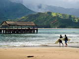Photo: Surfers walk along the shoreline at Hanalei Bay, Kauai, Hawaii 