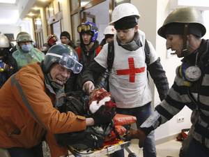 An anti-government protester injured during clashes with riot police receives medical care at a makeshift hospital in Kiev