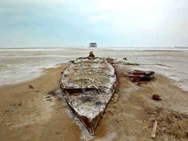 A wreckage of a boat is stuck in the solidified salts and sands at Lake Orumieh