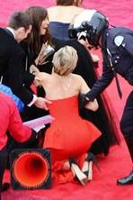 Head over heels: J-Law falls over (again) on the Oscars red carpet