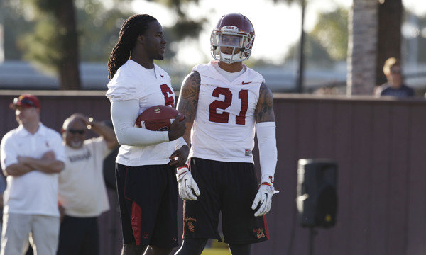 USC's Josh Shawn, left, and Su'a Cravens talk during a spring practice session on March 13.