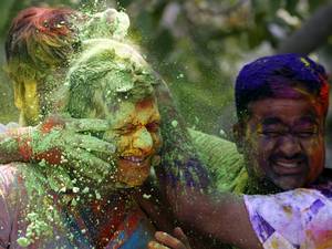 Hindu devotees play with colored powder during Holi festival. Known as the festival of colours, Holi is an ancient Hindu festival celebrated each year in winter around the time of the vernal equinox