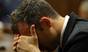 Oscar Pistorius places his head in his hands as he listens to the cross examination during his trial in court in Pretoria