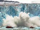 Visitors witness a huge chunk falling from Monaco Glacier, Spitsbergen, Norway in Jul 2013