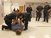 Female correctional officers take down an inmate at Dallas County Jail. 