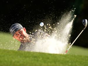 Ryan Moore of the US plays a shot out of a bunker during the first round of the 78th Masters Golf Tournament at Augusta National Golf Club in Augusta, Georgia