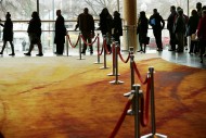 People seeking employment wait in line to enter a Washington job fair on March 28