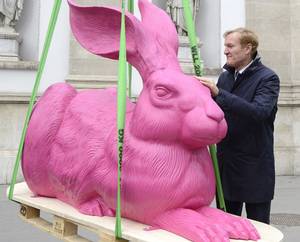 Museum director Klaus Albrecht Schroeder stands next to a large pink 'Duerer Rabbit' sculpture by German artist Ottmar Hoerl that is lifted at the top of the Albertina-wing, a part of the museum Albertina in Vienna, Austria