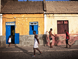 Photo of people walking in front of houses in the town of Ponta do Sol on the island of Santo Antao in Cape Verde.