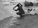 Photo: Photographer washing film in Gulf of Alaska