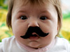 Photo: Baby wearing a fake mustache 