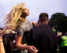 Members of the crowd are carried away by security and medical teams after they started to be crushed at the gig in Hyde Park