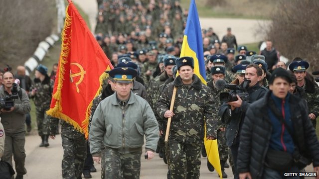 Colonel Yuli Mamchor (L), commander of the Ukrainian military garrison at the Belbek airbase, leads his unarmed troops to retake the Belbek airfield from soldiers under Russian command in Crimea 