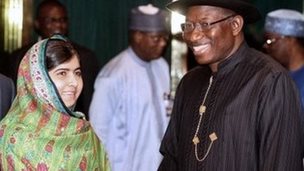 Pakistani education activist Malala Yousafzai (2nd R) shakes hands on 14 July 2014 with Nigerian President Goodluck Jonathan (R) next to her father, Ziauddin Yousafzai (2nd L), and Malala Fund committee member Shiza Shahid (L) at the State House in Abuja.