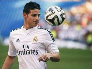 22 July 2014: Colombia's soccer player James Rodriguez controls the ball during his presentation at the Santiago Bernabeu stadium in Madrid
