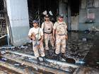 Pakistani Rangers keep watch at the fire-damaged premises of a cold-storage cargo facility at the Jinnah International Airport in Karachi on 10 June 2014, following the 9 June attack by militants