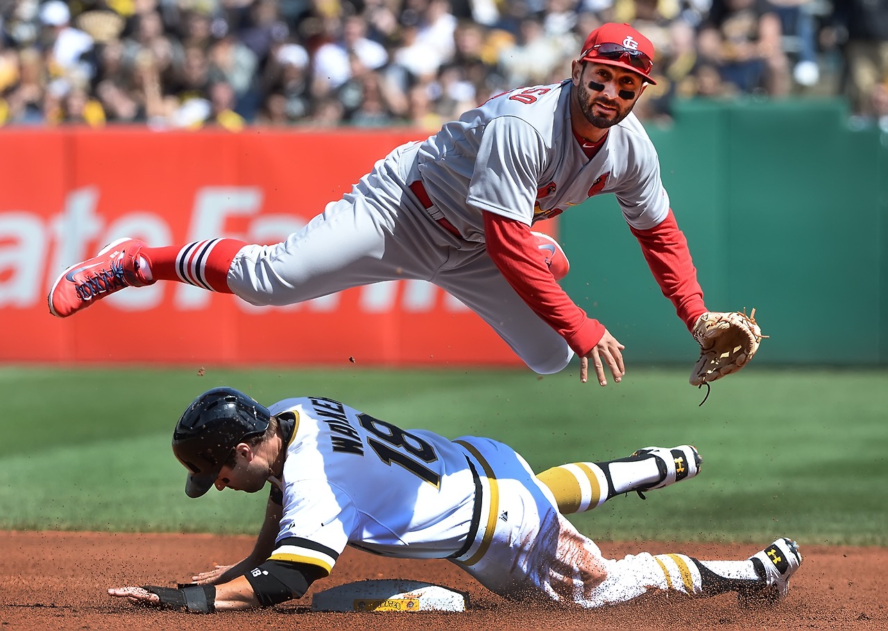 Neil Walker upends Daniel Descalso as Descalso throws to first base to complete a double play at PNC Park on Saturday, April 5, 2014. 
&#8212;Peter Diana/Post-Gazette