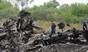 Rescuers stand on the site of the crash of a Malaysian airliner near the town of Shaktarsk, in rebel-held east Ukraine