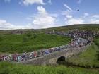 The Tour de France peloton rides over a bridge on the Grinton Moor, Yorkshire, earlier this month