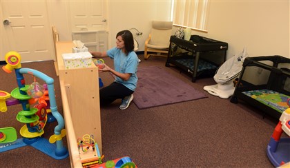20140730RARseennursery5-4 Kayla Olson sorts toys in the infant area at Jeremiah's Place in East Liberty. 