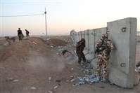  Kurdish Peshmerga fighters take cover during airstrikes by the U.S. forces targeting Islamic State militants near the Khazer checkpoint outside of the city of Irbil in northern Iraq today.