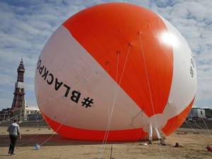 15 August 2014: A giant inflated beach ball sits on the sand at Blackpool Beach in Blackpool
