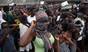 A crowd enters the grounds of an Ebola isolation center in the West Point slum on August 16, 2014 in Monrovia, Liberia. A mob of several hundred people, chanting, 