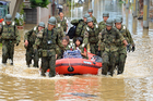Children and elder people are resucued by the members of Japan Ground Self-Defense force by boat in Fukuchiyama, Kyoto, Japan. Fukuchiyama City recorded 303.5 millimeters torrential rain in 24 hours