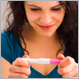 woman looking at pregnancy test