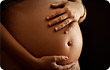 woman cradling pregnant belly