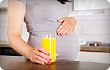 pregnant woman with orange juice