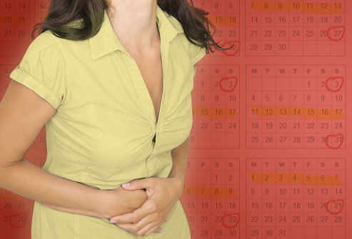 Woman with cramps and calendar