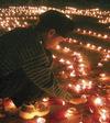 Diwali: boy lighting lamps [Ajay Verman—Reuters/Corbis] 