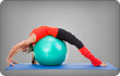 woman stretching on exercise ball