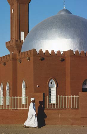Khartoum: man walking past a mosque
