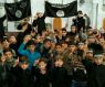 Children pose with ISIS flags in Raqqa, Syria in an undated image.