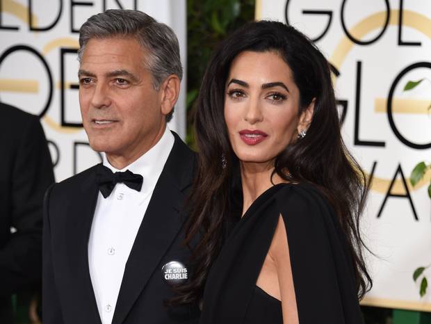 George and Amal Clooney wear 'Je suis Charlie' badges at the Golden Globes 2015