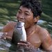 A Naga man, in northwest Myanmar, with a fish he caught after it was stunned by dynamite thrown into a creek.