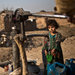 Afghan refugees pumped water by hand in a slum of Islamabad, Pakistan. An official warned that Pakistan could become “a water-starved country.”