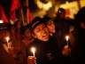 Protestors shout slogans as they hold candles during a candle light vigil to mark the first anniversary of the Delhi gang rape, in New Delhi, December 16, 2013.